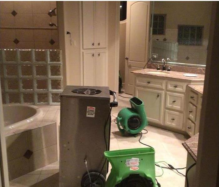 A bathroom with machines for cleaning mold damage